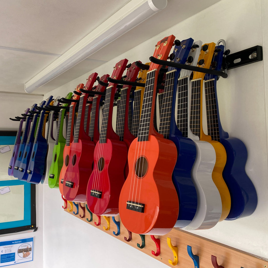 ukuleles stored on a wall in a school