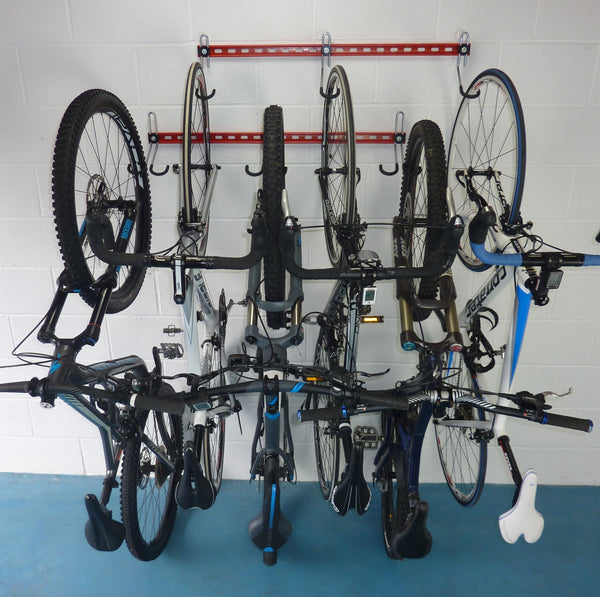 vertical bike rack - Two GearHooks bike storage racks mounted one above the other and shown holding  2 mountain bikes, 1 electric bike and 3 road bikes