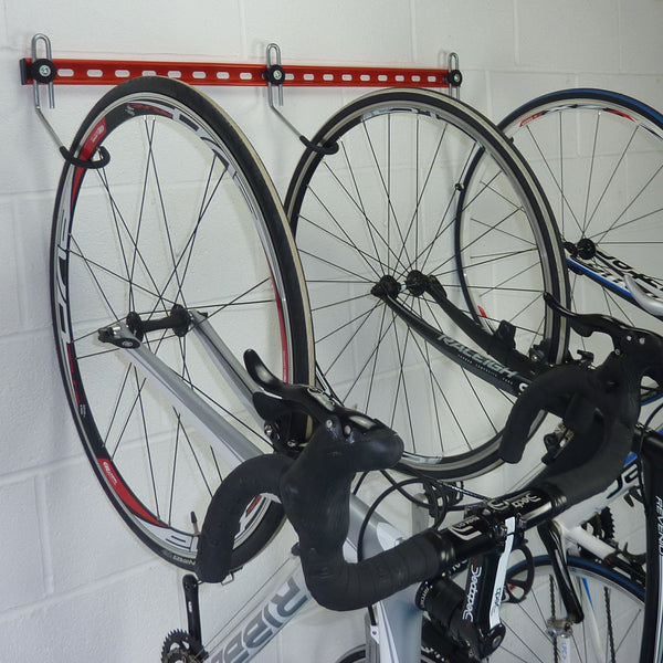 Wall mounted bike rack shown with with 3 road bikes