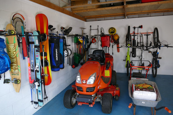 Garage Wall Storage Rack. Inside of a garage with wall mounted storage racks showing how bikes, sports equipment and tools can be stored on wall mounted racks