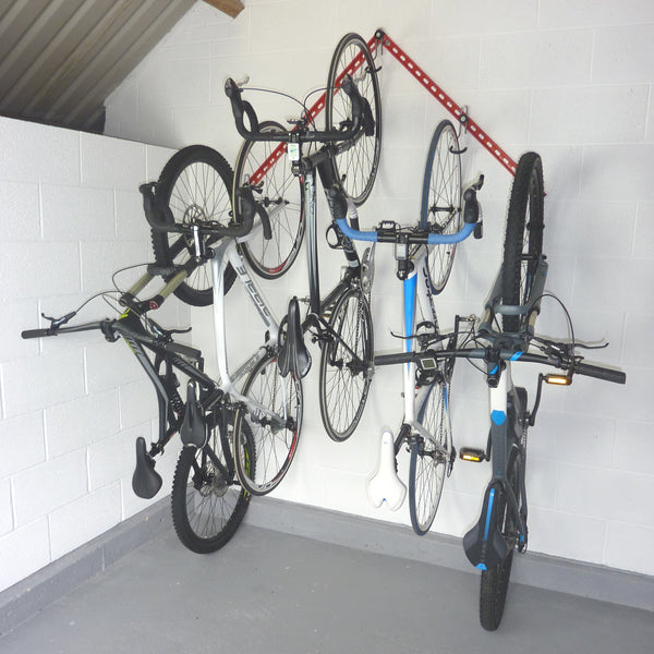 vertical bike storage rack showing 2 GearRails and 5 bike storage hooks mounted in an inverted v shape with 2 mountain bikes and 3 road bikes