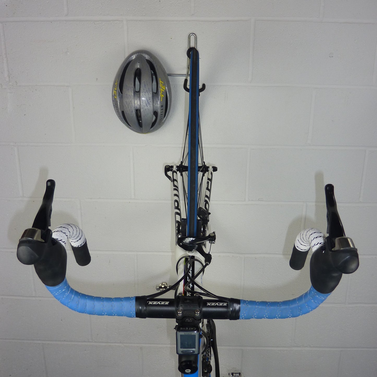 Bike hanger for 1 bike plus helmet, backpack and coat shown with a road bike and helmet