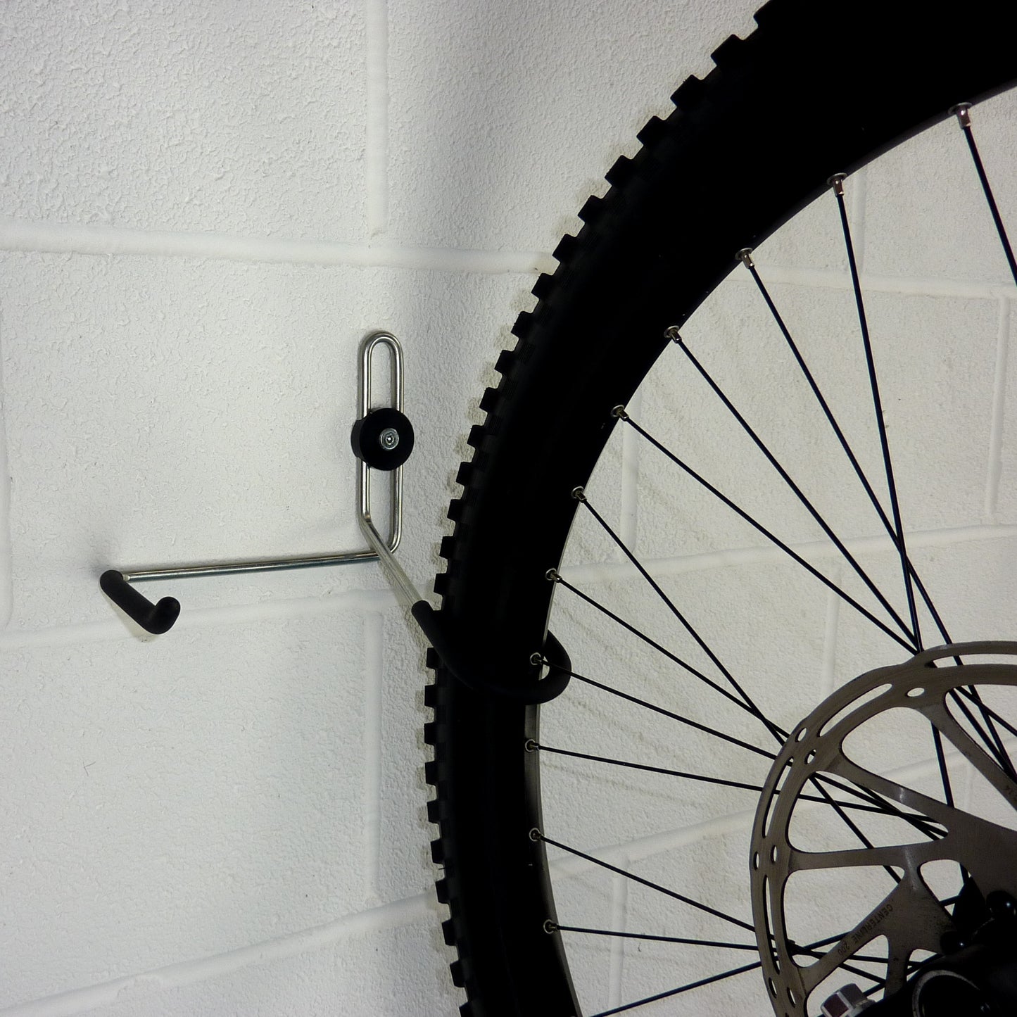 Bike hanger for 1 bike plus helmet, backpack and coat shown with a mountain bike