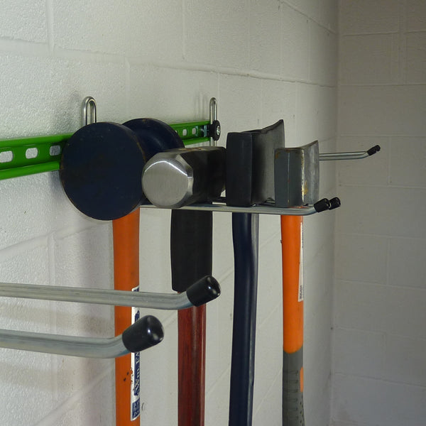Garden tool rack showing a hook with maul, sledgehammer and 2 axes