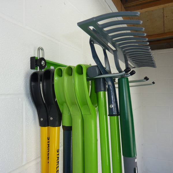 garden tool storage showing a hook with 8 tools: spades, shovels, fork, lawn edger, Hoe and rake