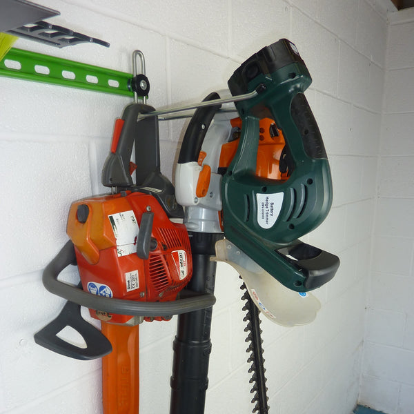 Heavy duty garden tool storage with petrol chainsaw, petrol leaf blower and electric hedge trimmer on one hook